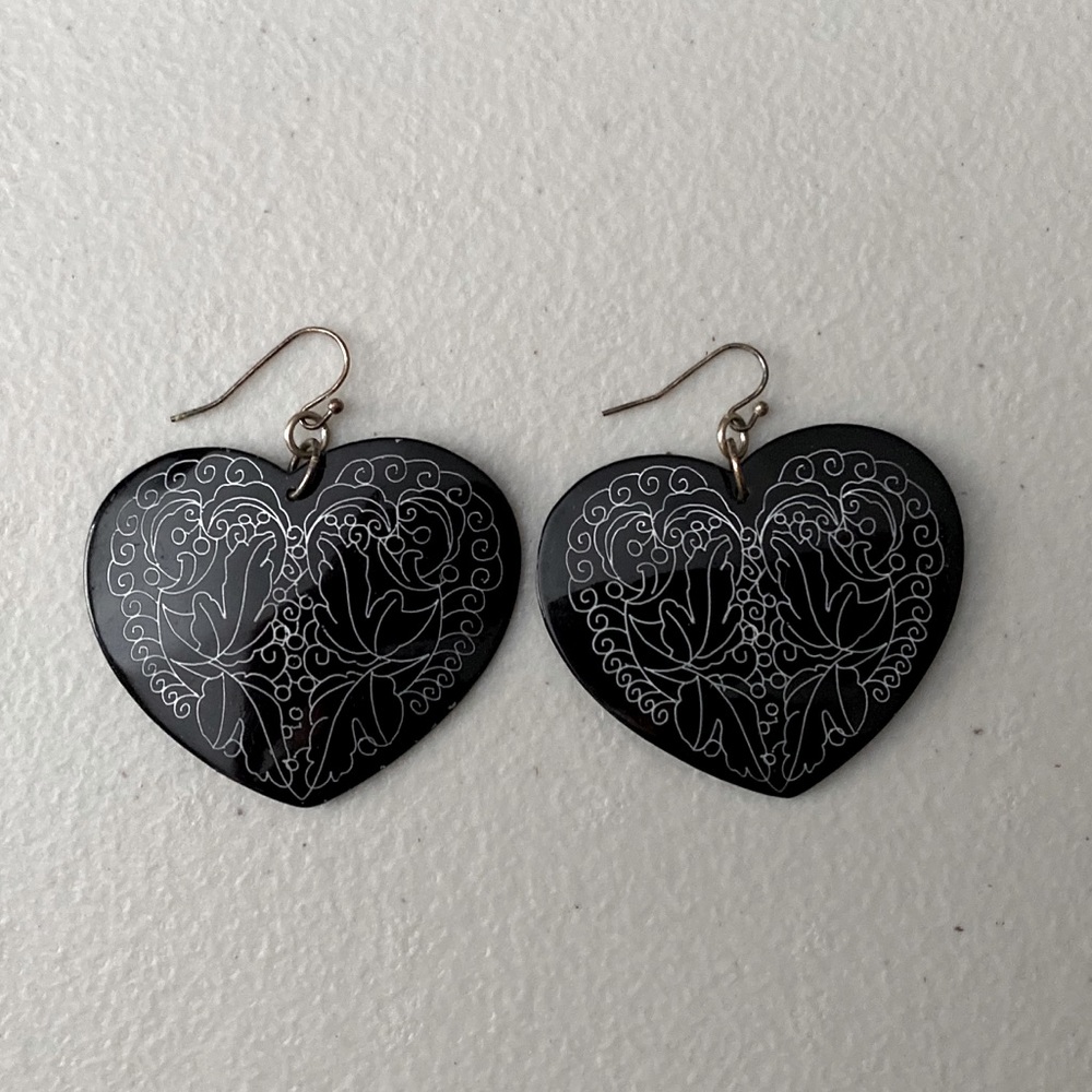 Black, heart shaped earrings.